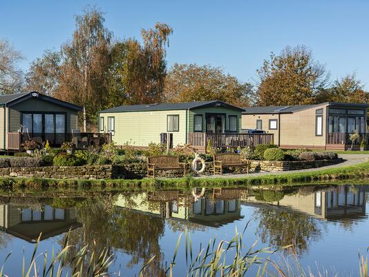 Autumn colours across the lake at Arrow Bank Country Holiday Park, Herefordshire