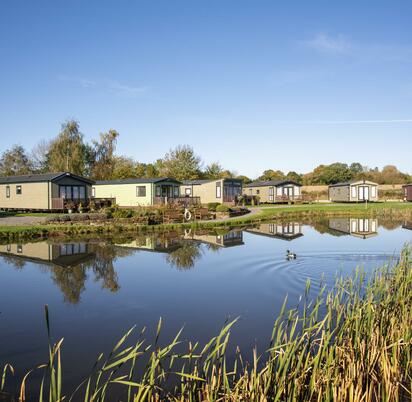 Static caravans for sale on site 5 star park photo across the lake at Arrow Bank