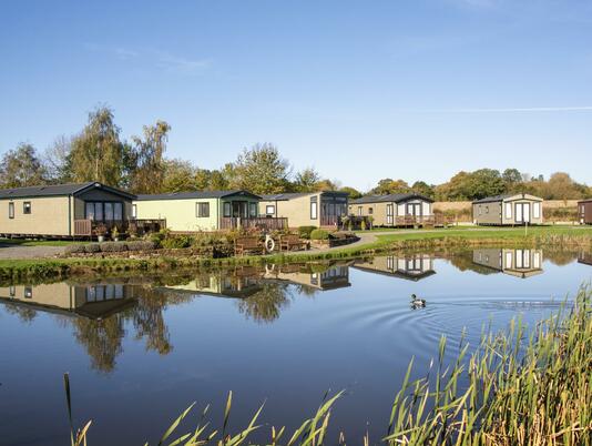 Static caravans for sale on site 5 star park photo across the lake at Arrow Bank